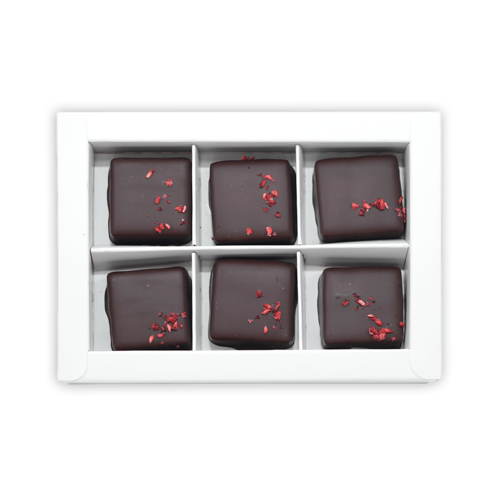 Six Fjåk chocolate-coated raspberry caramels in white box
