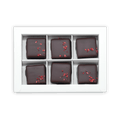 Six Fjåk chocolate-coated raspberry caramels in white box