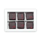 Six Fjåk chocolate-coated raspberry caramels in white box