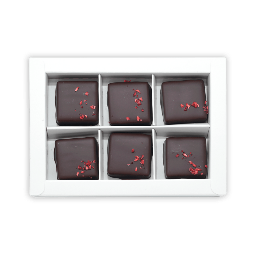 Six Fjåk chocolate-coated raspberry caramels in white box