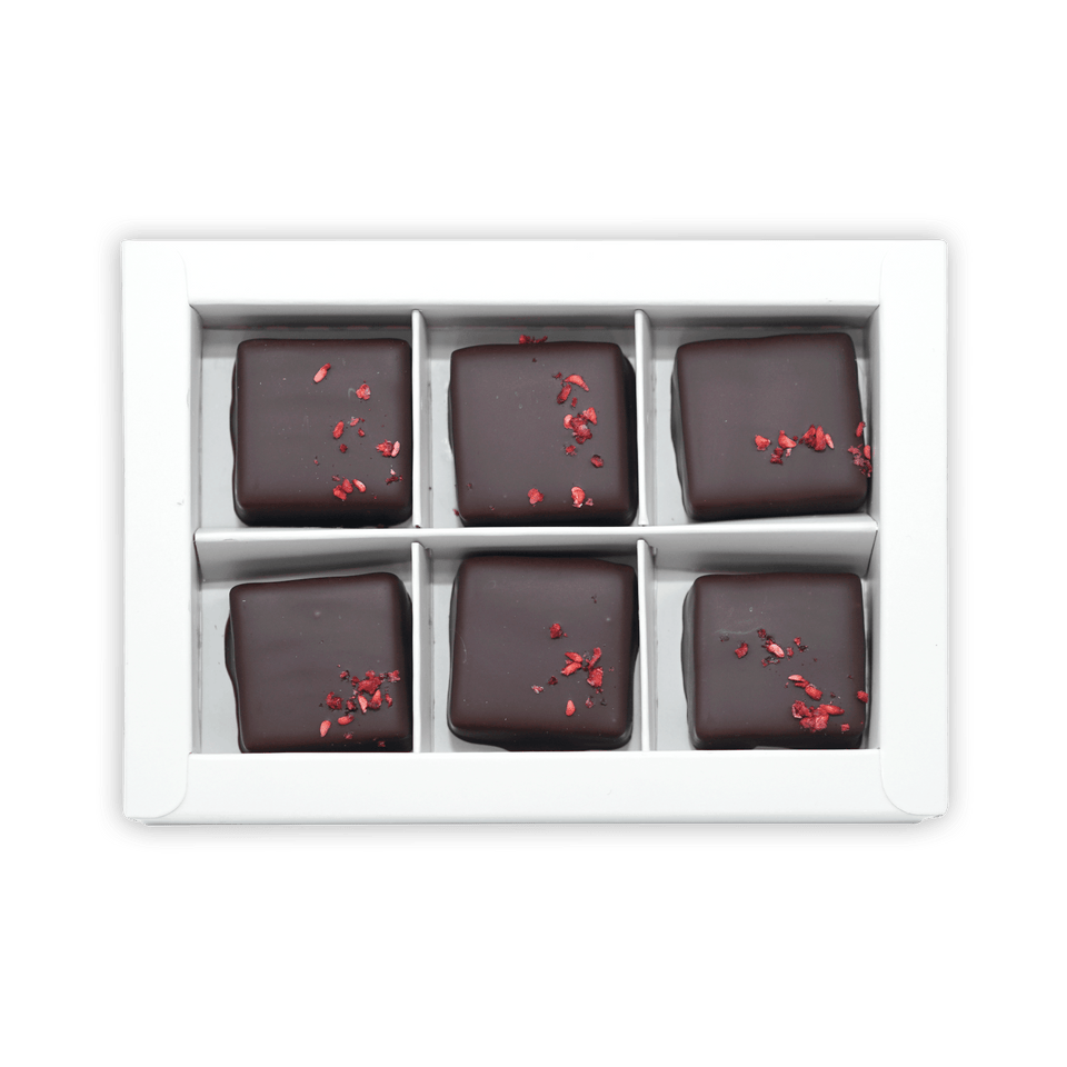 Six Fjåk chocolate-coated raspberry caramels in white box