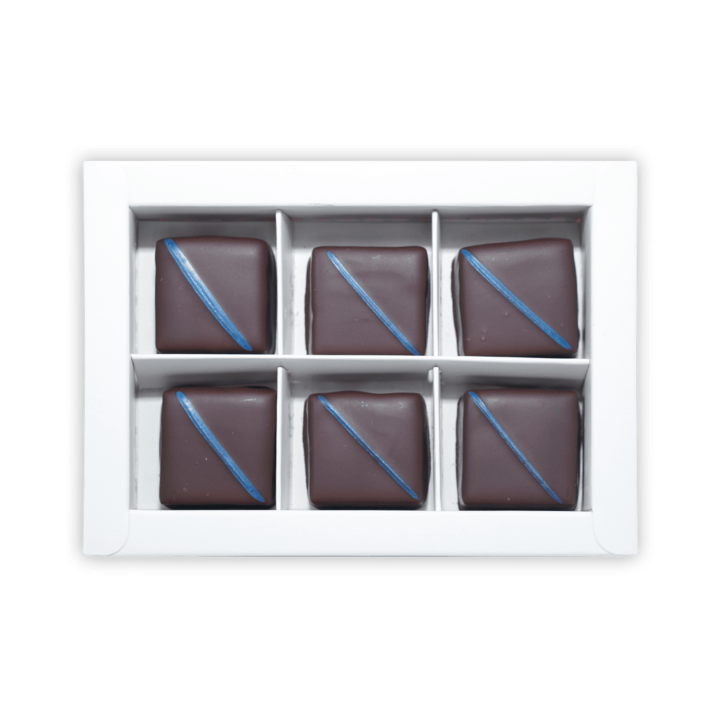 Six Fjåk dark chocolate salted caramels with blue icing in white box