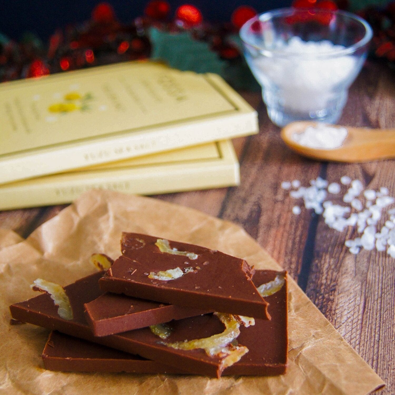 Fossa Dark Milk Chocolate Yuzu Sea Salt 54% bars with citrus peel on parchment