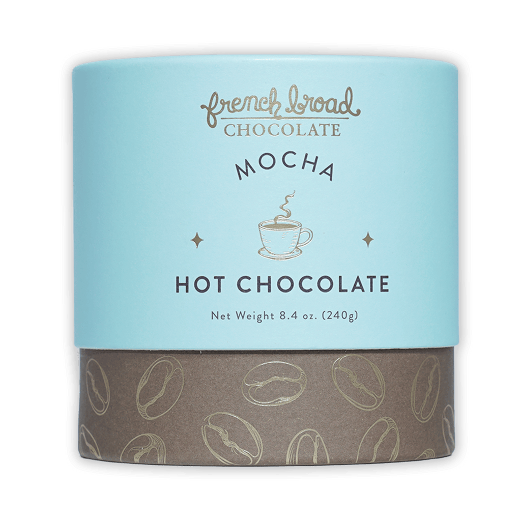 French Broad Mocha Hot Chocolate in blue-brown canister with coffee beans