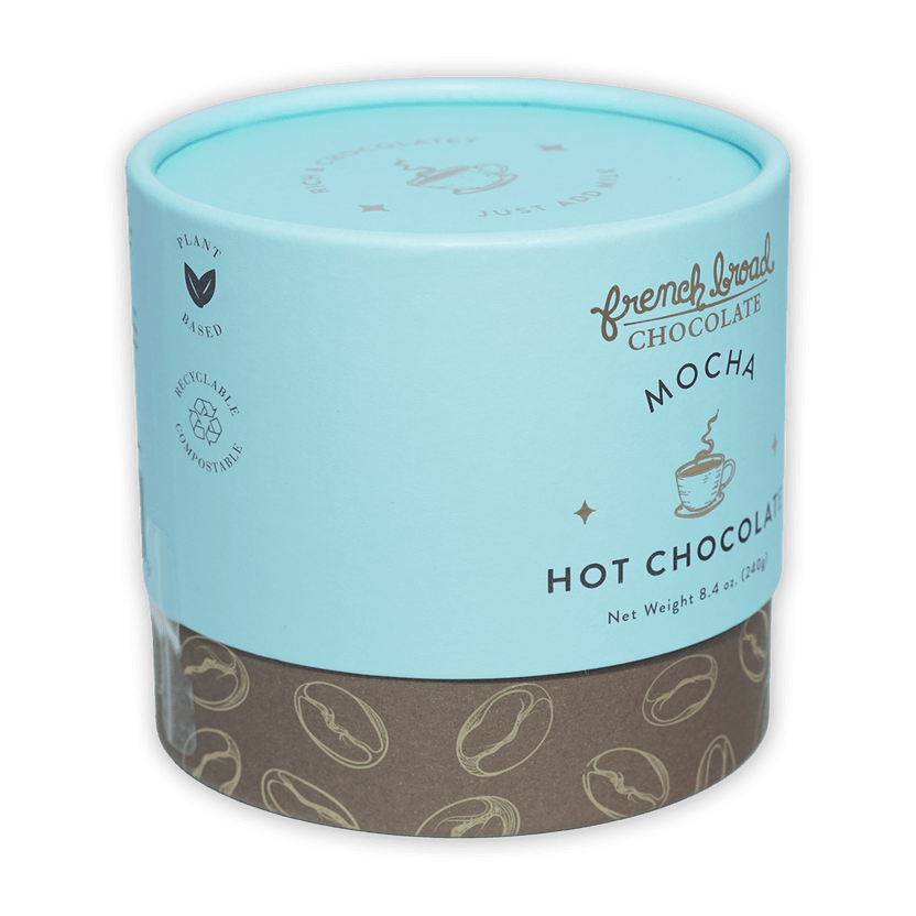 French Broad Mocha Hot Chocolate in light blue cylinder with coffee beans