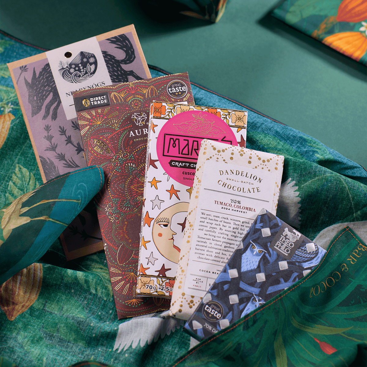 Five craft chocolate bars fanned out on Bar & Cocoa crane print furoshiki