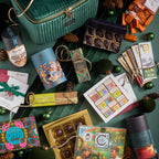 Emerald green velvet Grand Chocolate Voyage gift box with gold zipper handle