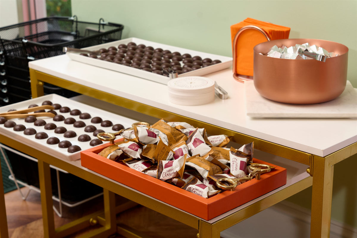 Trays of chocolates and a copper bowl on a table in the Greensboro shop