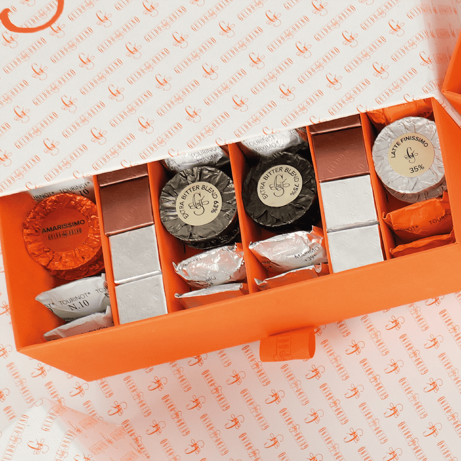 Guido Gobino orange gift box with Ghirardelli assorted wrapped chocolates