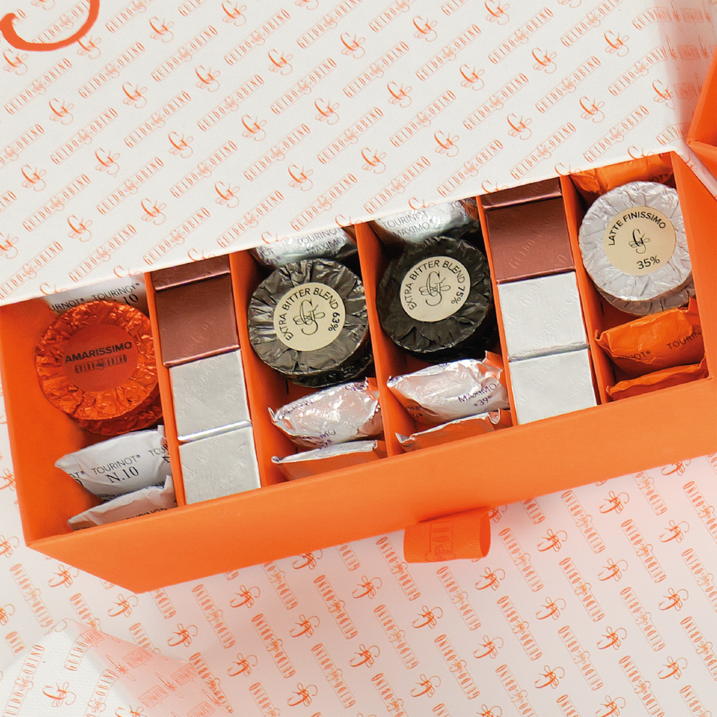 Guido Gobino orange gift box with Ghirardelli assorted wrapped chocolates