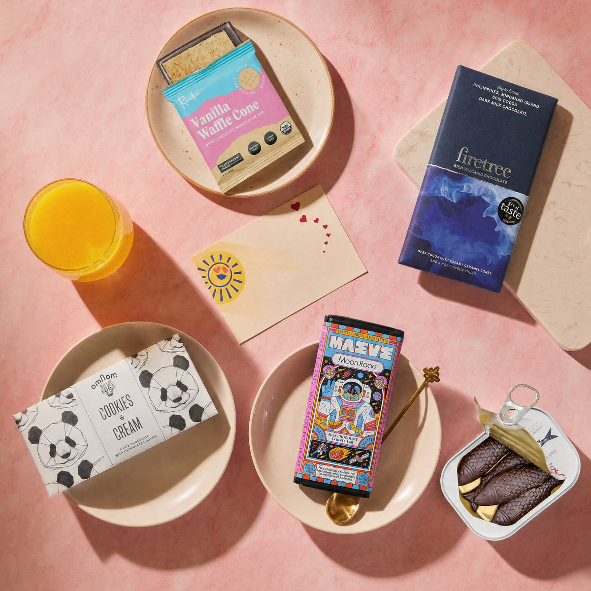 Little Chocolate Explorer gift bundle, chocolate bars and treats with orange juice.