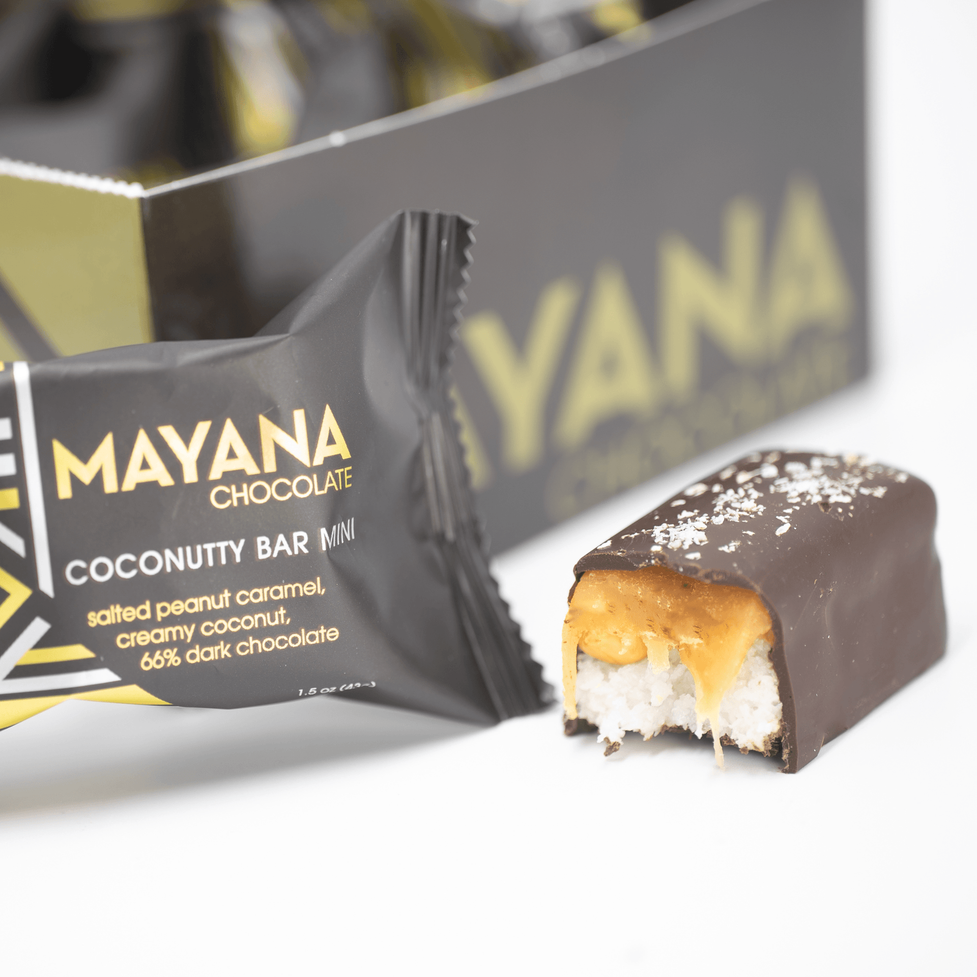 Mayana Chocolate Mini Coconutty Bar with bite revealing coconutty filling