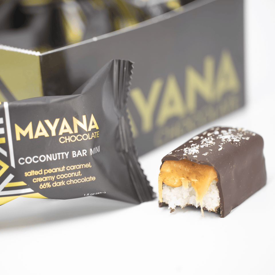 Mayana Chocolate Mini Coconutty Bar with bite revealing coconutty filling