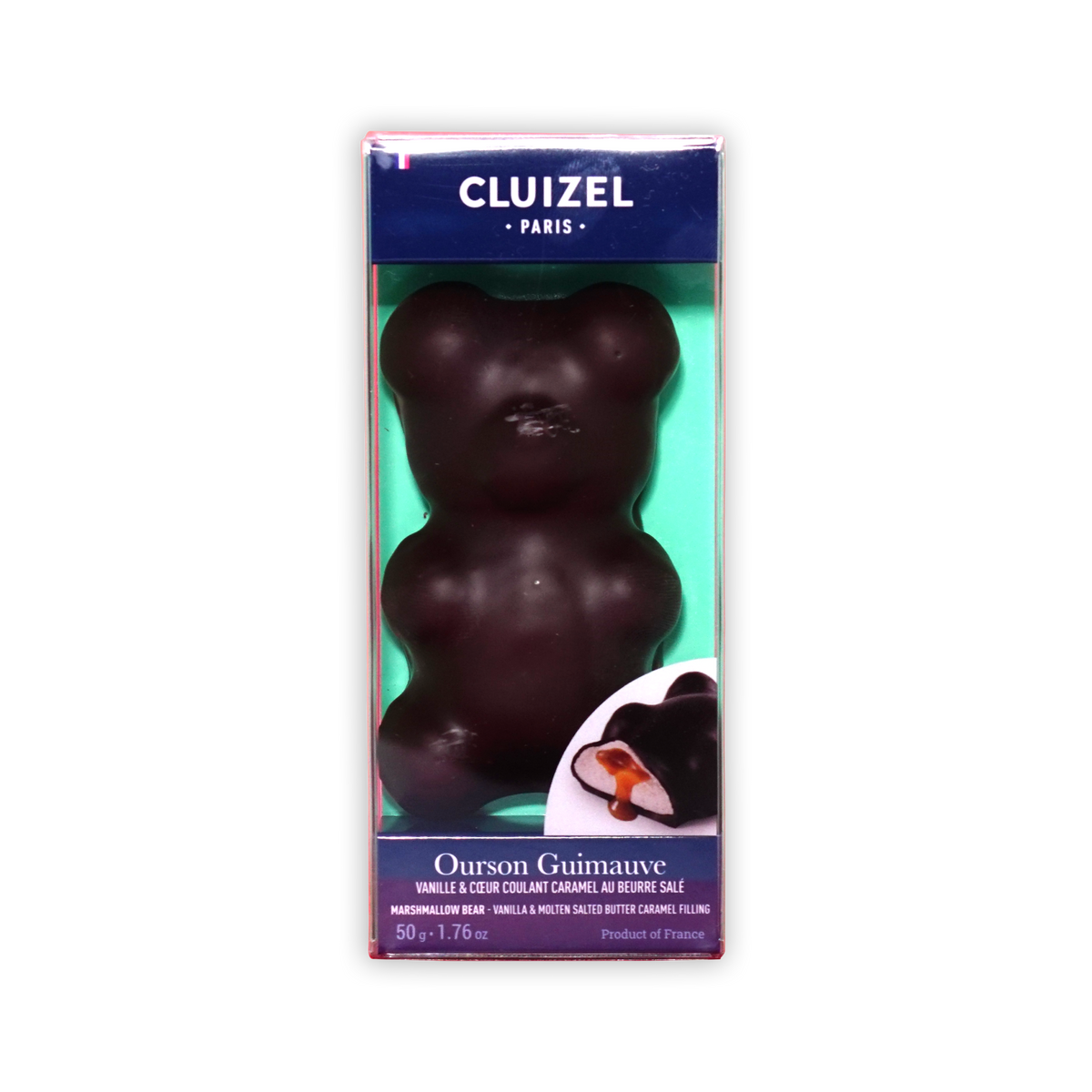 A Cluizel Paris Ourson Guimauve chocolate bear in a clear box with blue borders and a green insert on a black background.