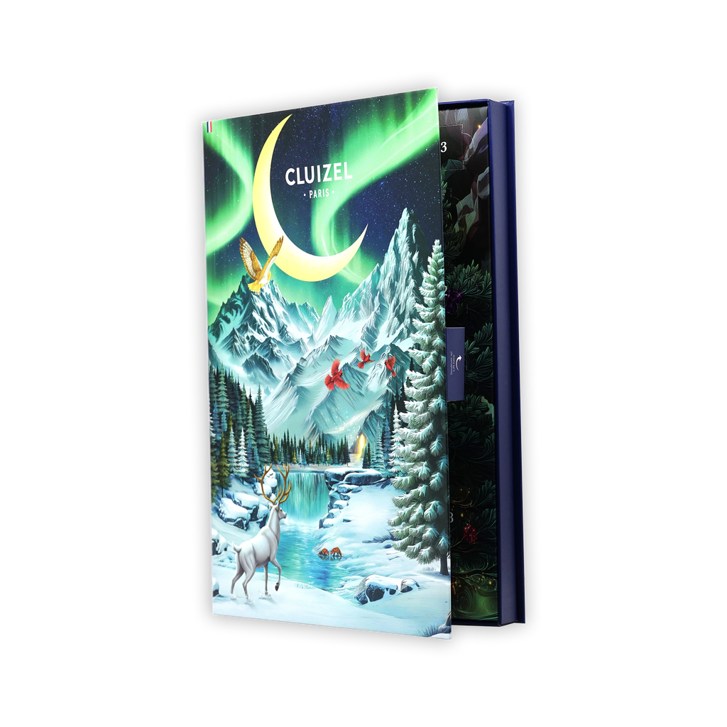 A partially open Cluizel Paris advent calendar box showing a snowy mountain scene, a white stag, and northern lights.