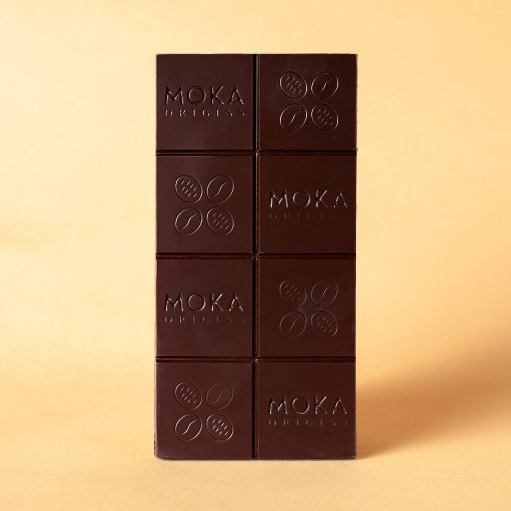 Unwrapped Moka Dark Uganda 72% bar on a warm beige background