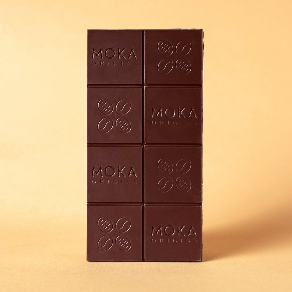 Unwrapped Moka Dark Milk 58% bar on a warm beige background