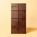 Unwrapped Moka Dark Cameroon 72% bar on a warm beige background