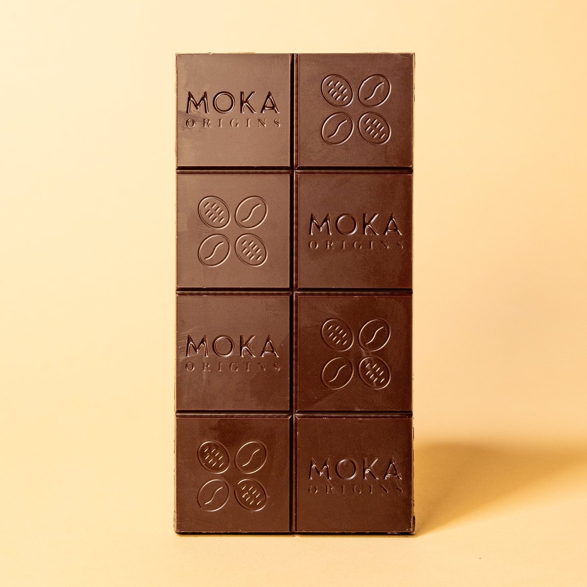 Unwrapped Moka Dark Cameroon 72% bar on a warm beige background