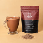 Moka Drinking Chocolate Mexican Spice 72% pouch beside a mug of prepared drinking chocolate