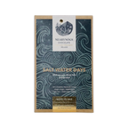 A rectangular dark blue wrapper with wave patterns for nearynogs chocolate dark salt water days 65% bar with gold seal