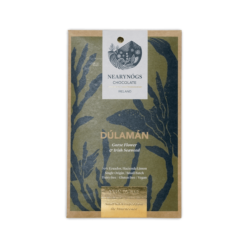 A rectangular package of nearynogs dulaman dark chocolate with irish seaweed gorseflower featuring green navy blue seaweed design and gold foil accents