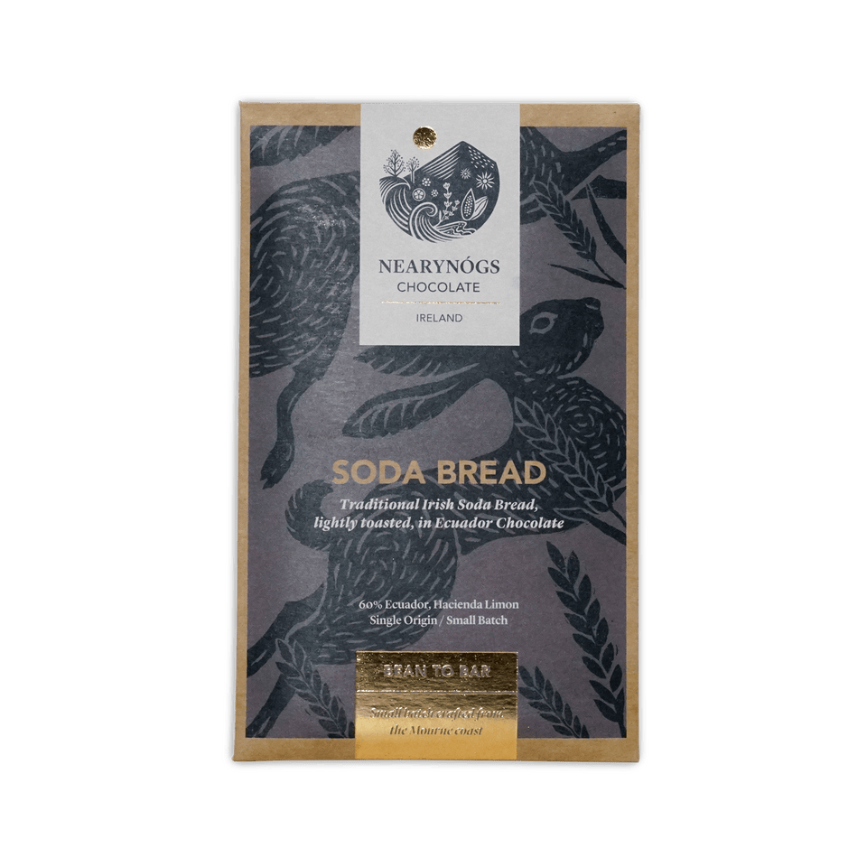 A rectangular package of nearynogs irish soda bread 60% chocolate with a dark gray wrapper featuring black birds and gold foil text