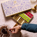 Domori Great Classics No 8: elegant cream gift box with purple floral pattern, gold ribbon, assorted chocolates