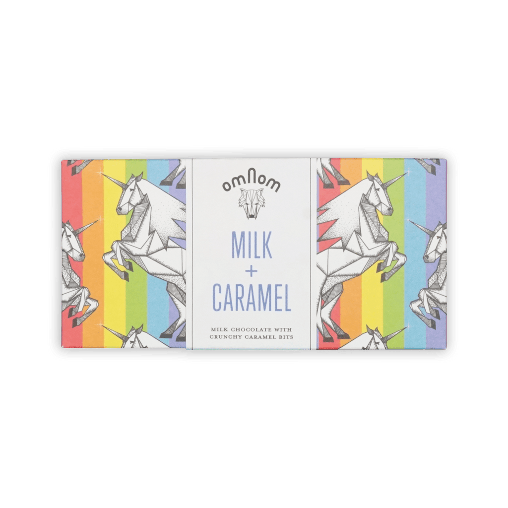 Omnom bar in rainbow-stripe wrapper with origami unicorns, white center panel reading Milk + Caramel.