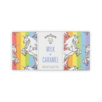 Omnom bar in rainbow-stripe wrapper with origami unicorns, white center panel reading Milk + Caramel.