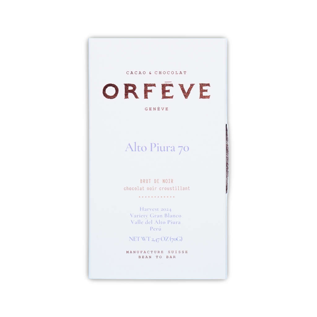A white Orfeve Alto Piura 70 chocolate box on a black background, featuring rose gold and light blue printed text.