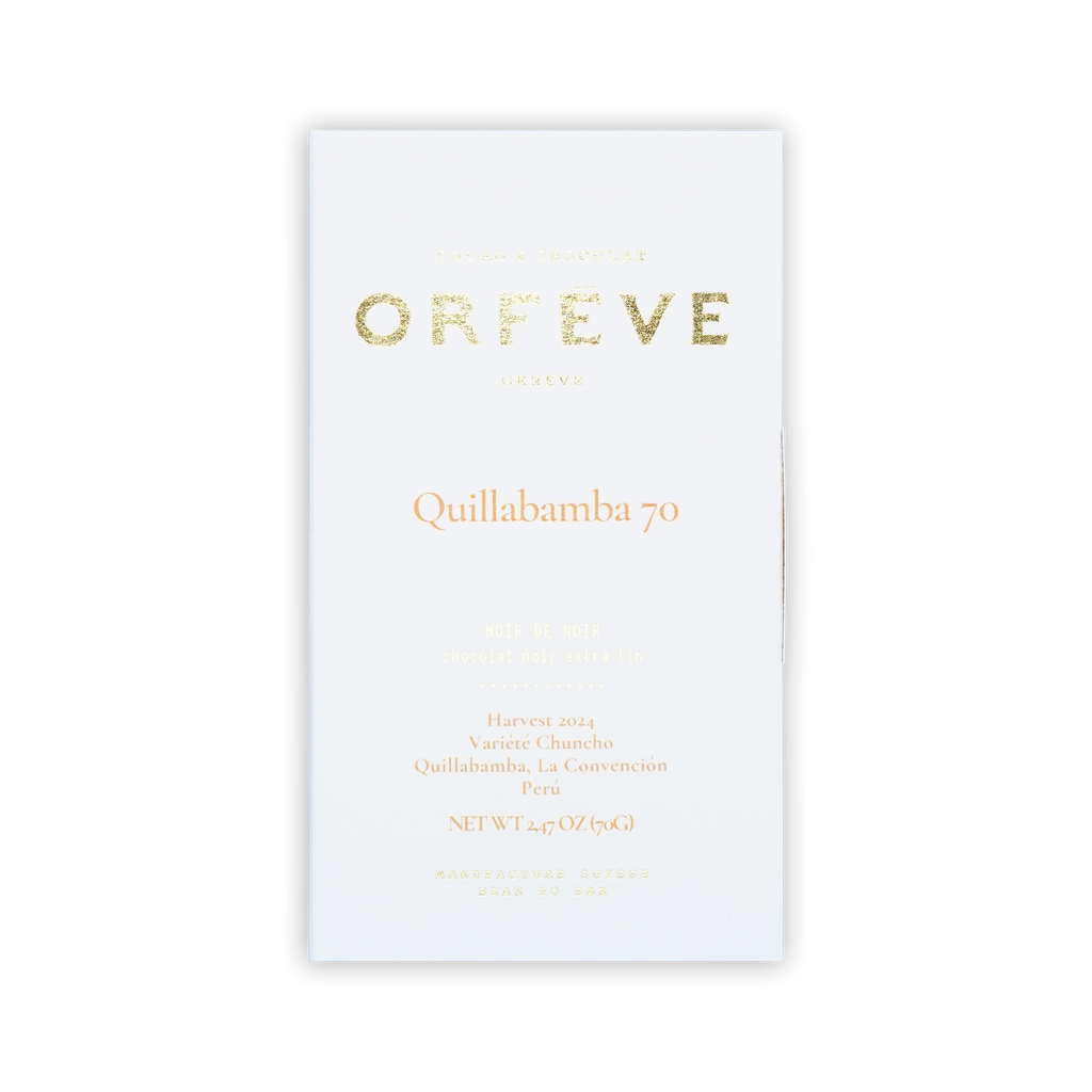 A white Orfeve Quillabamba 70 chocolate box with gold foil lettering on a black background.