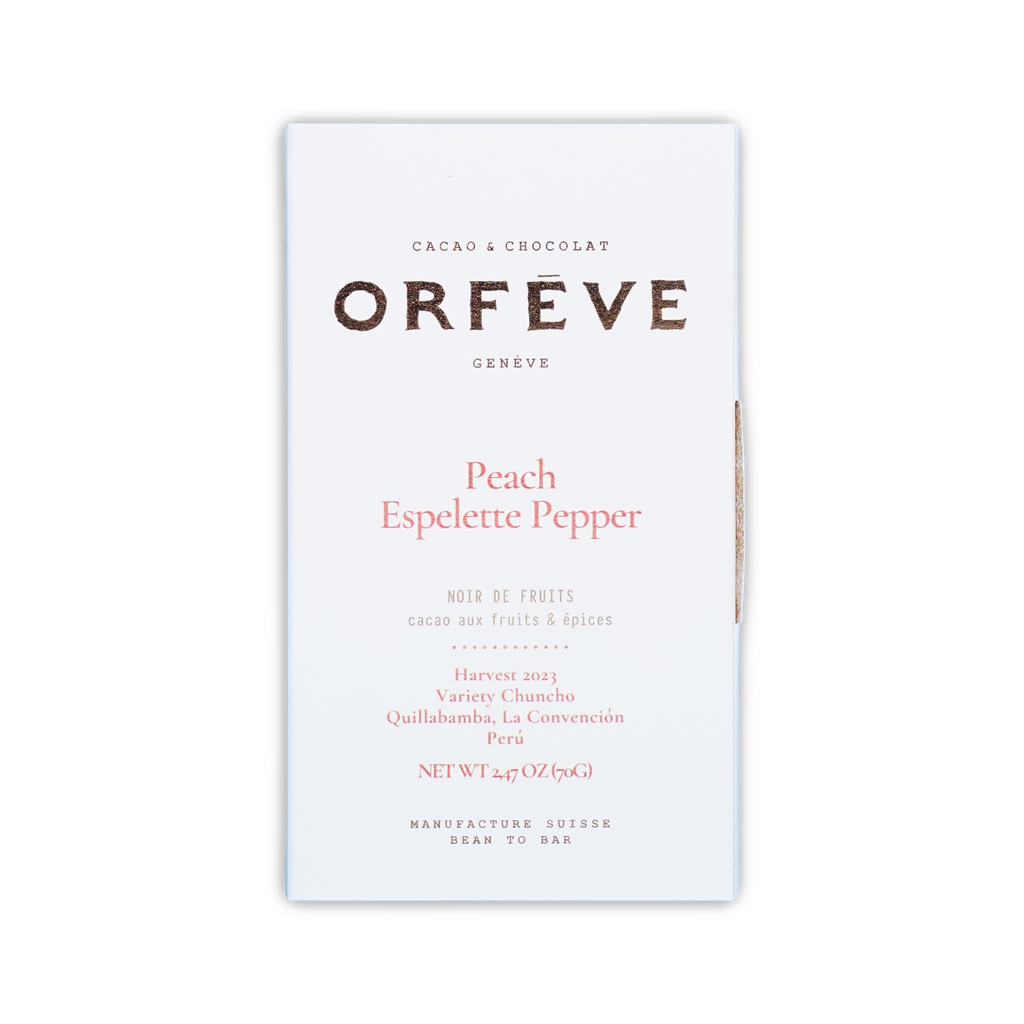 A white rectangular box of Orfeve Peach Espelette Pepper chocolate on a black background.