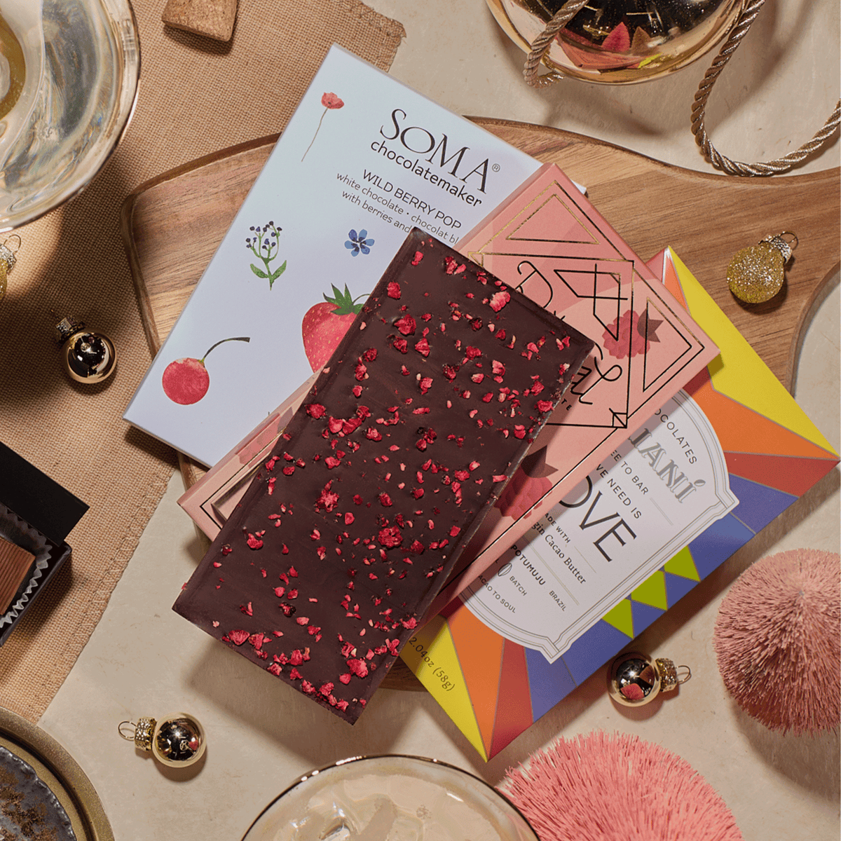 Close-up of Pop, Clink, Cocoa chocolate bars, including a raspberry-topped dark bar