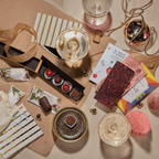 Flat lay of Pop, Clink, Cocoa celebration chocolates with sparkling wine glasses