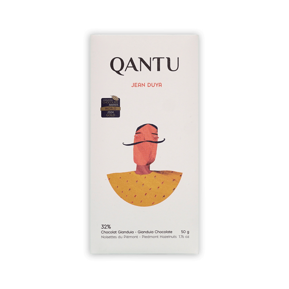 Qantu Jean Duya 32% Gianduia bar, cream box with an illustrated mustached figure in a yellow cape, 50g