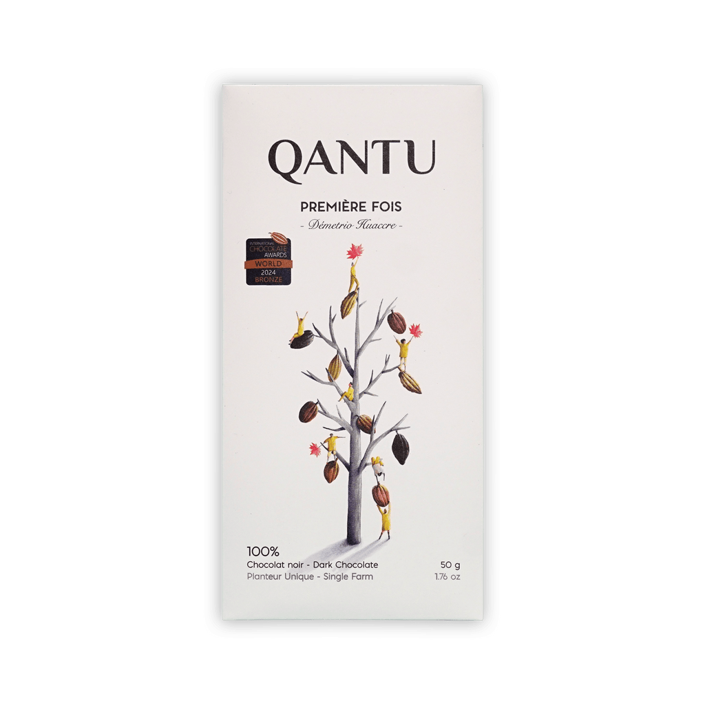 Qantu Premiere Fois 100% dark chocolate bar, cream box with an illustrated bare tree hung with cacao pods, 50g.