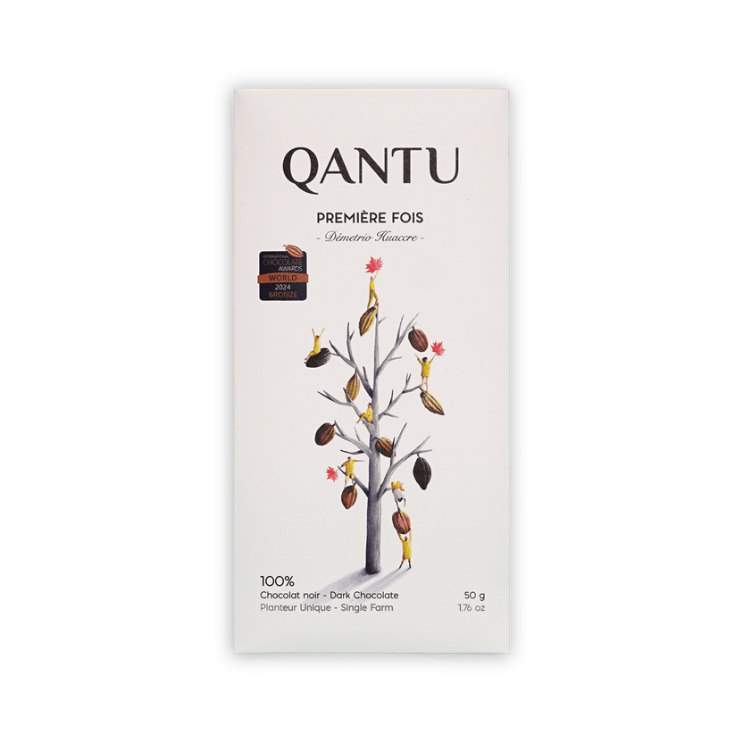 Qantu Premiere Fois 100% dark chocolate bar, cream box with an illustrated bare tree hung with cacao pods, 50g.