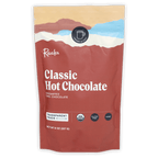 Raaka Classic Hot Chocolate in red resealable pouch with mountain graphics