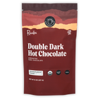 Raaka Double Dark Hot Chocolate maroon pouch with sunset design, organic cane sugar-free certifications