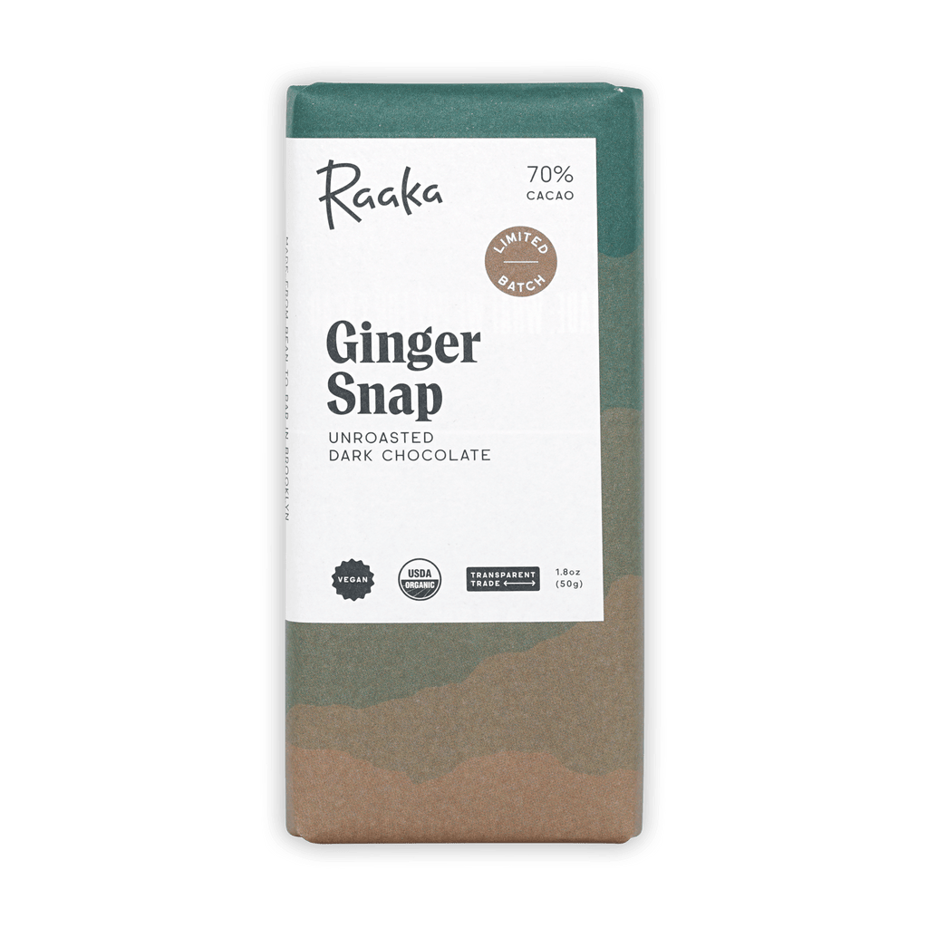 Raaka Ginger Snap 70% unroasted dark chocolate bar in a green and tan patterned wrapper on a black background.