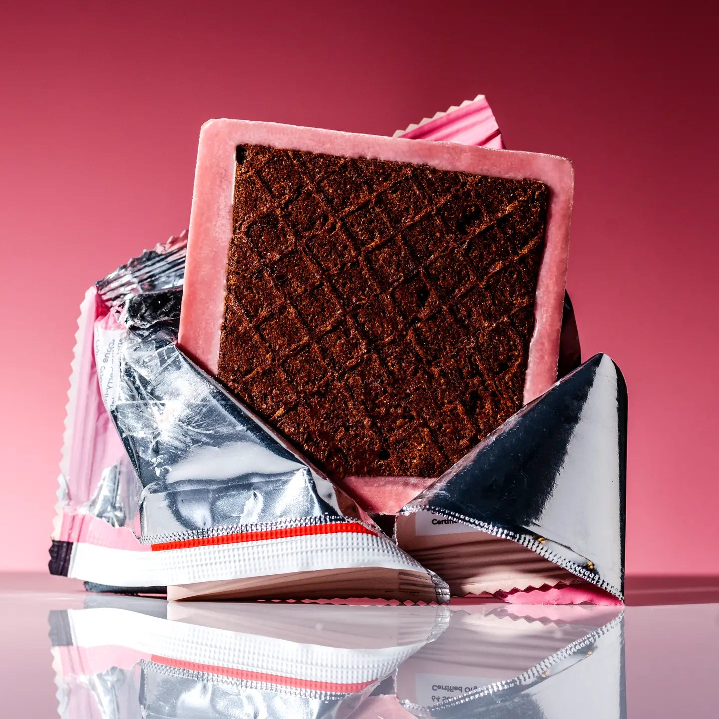 Raaka Strawberry Dipped Waffle Cone: pink silver foil bar with grid chocolate interior