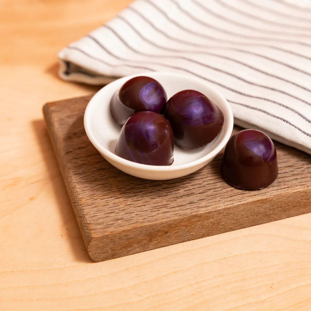 Deep purple glossy Ranger Marionberry Bonbons in white bowl