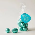 A bag of teal foil wrapped dark chocolate easter eggs with a blue rump street label from pump street solomon islands 72%