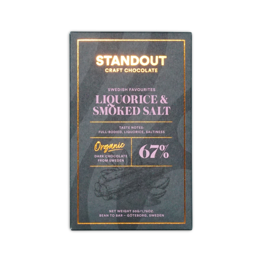 A sleek dark green rectangular bar of standout craft chocolate with gold foil lettering and subtle illustration