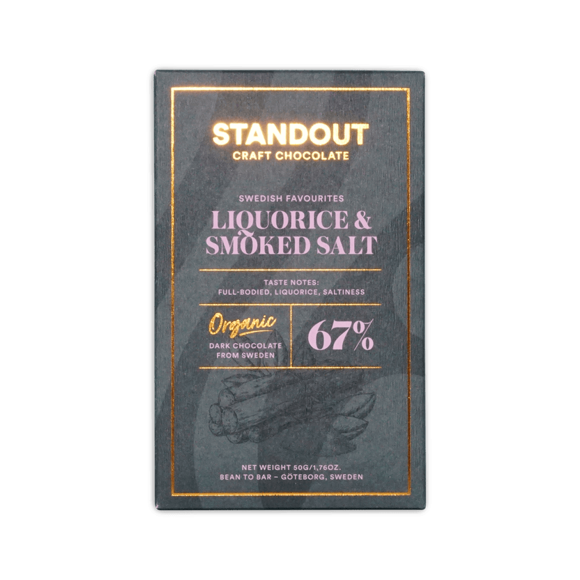 A sleek dark green rectangular bar of standout craft chocolate with gold foil lettering and subtle illustration
