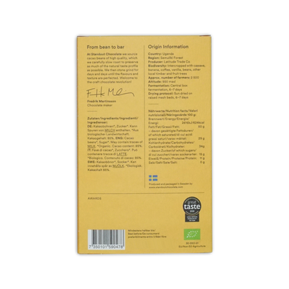 Yellow cardboard wrapper of Standout Chocolate Uganda Semuliki Forest 85 percent with black text and green organic logo