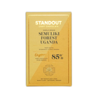 A golden-yellow rectangular chocolate bar wrapper from standout craft chocolate with gold foil lettering and a hexagonal flavor diagram for uganda semuliki forest 85 percent