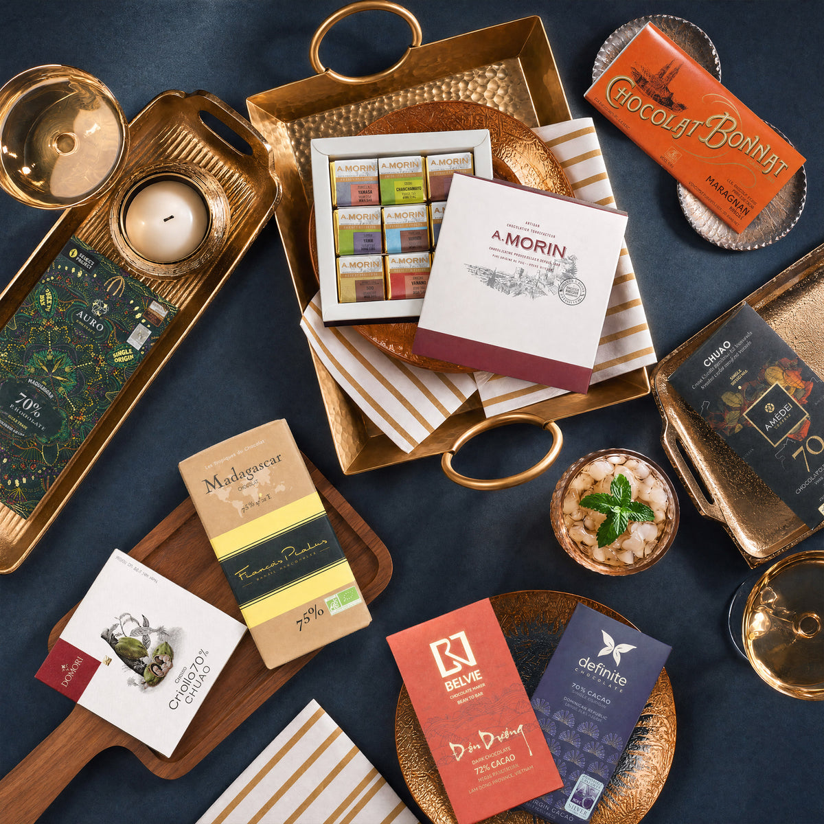 Sweet Amends Sorry dark chocolate gift bundle, bars and an A. Morin box on gold trays.