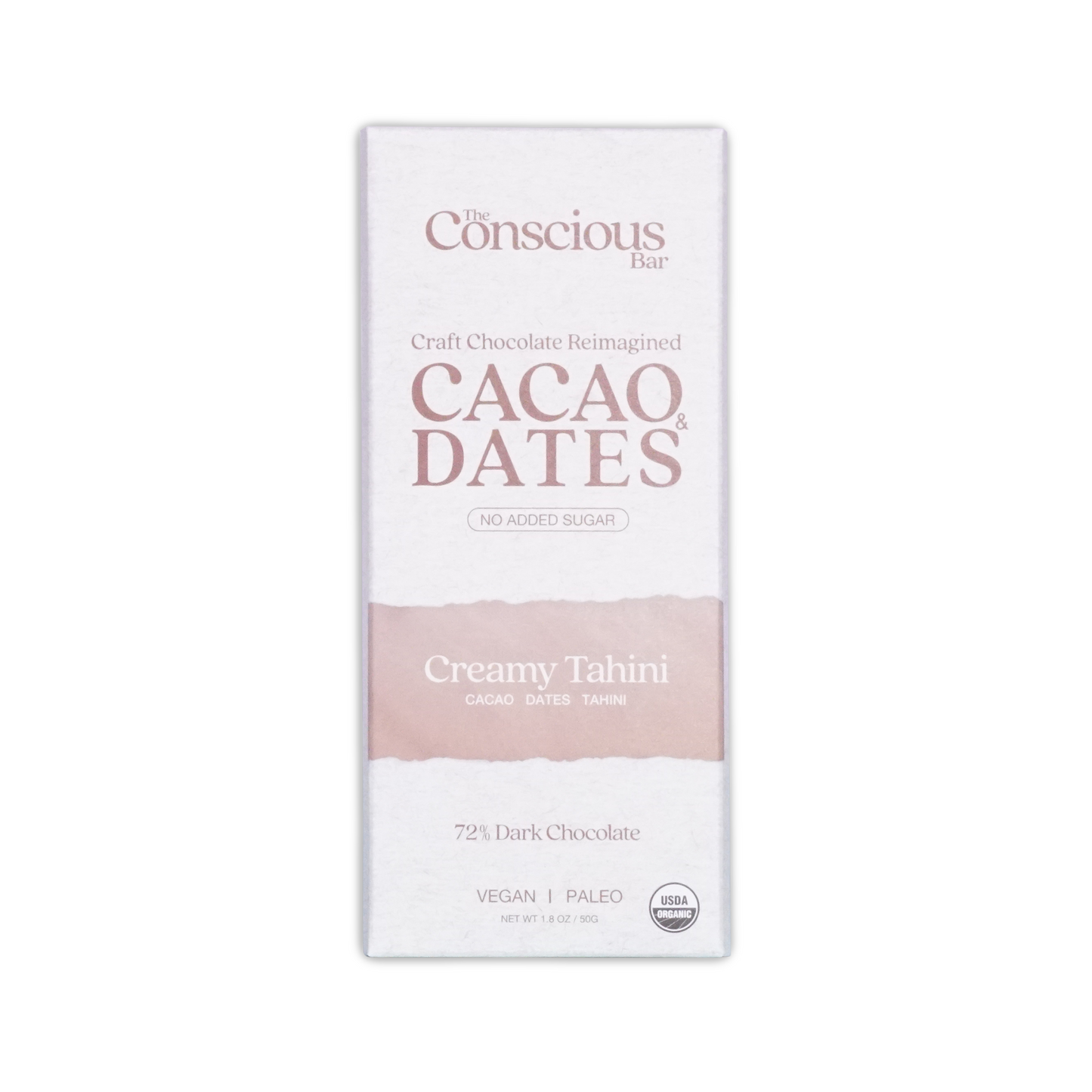 A white rectangular package of the conscious bar dark creamy tahini 72 percent cacao and dates chocolate bar with pink stripe